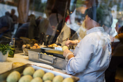 Man preparing food for sale at market stall