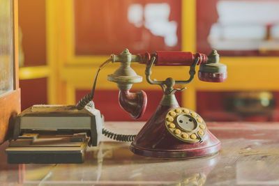 Close-up of old telephone on table