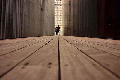 Surface level view of people standing boardwalk amidst buildings