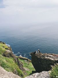 High angle view of rocks by sea against sky