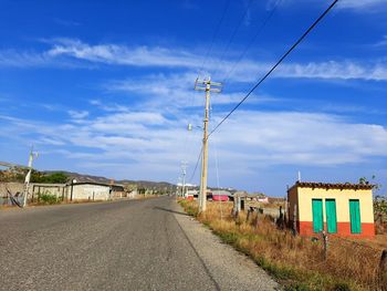 Road by building against sky