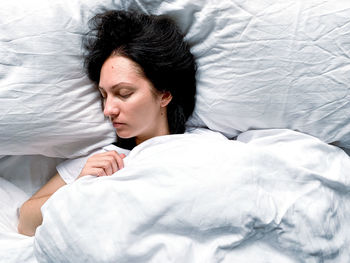 Young woman sleeping on bed