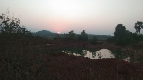 Scenic view of field against sky during sunset