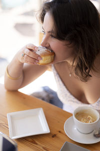 Close-up of boy eating food on table