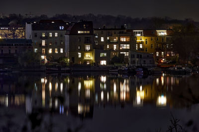 Reflection of buildings in city at night