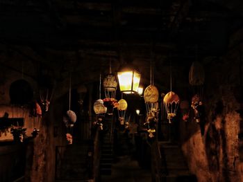 Illuminated lanterns hanging in building