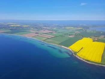 Aerial view of agricultural field against blue sky