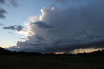 Scenic view of dramatic sky over silhouette landscape