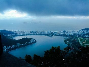 View of cityscape against cloudy sky