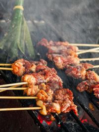 Close-up of meat on barbecue grill