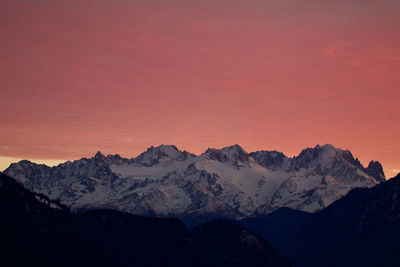 Scenic view of snowcapped mountains against sky during sunset