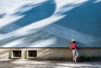 Full length of woman standing on wall