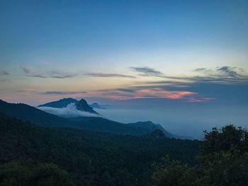 Scenic view of mountains against sky at sunset