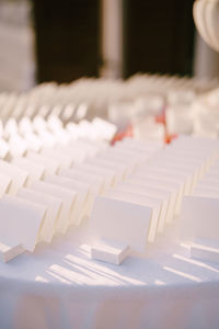 Close-up of white chairs on table