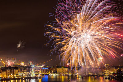 Firework display in city at night