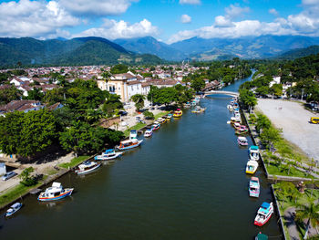 High angle view of boats in canal amidst buildings in city