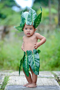 Portrait of cute baby girl standing outdoors