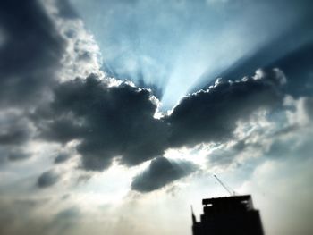 Low angle view of building against cloudy sky