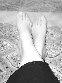 Close-up of young woman lying on tiled floor