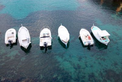 Boats moored on calm  shallow water