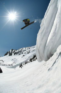 Low angle view of skier jumping from mountain