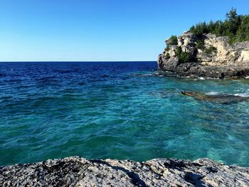 Scenic view of sea against clear blue sky