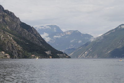 Scenic view of sea and mountains against sky