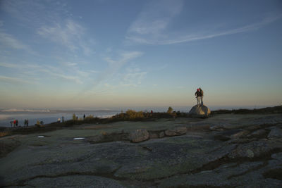 People at cadillac mountain in acadia national park against sky