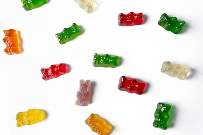 High angle view of multi colored candies on white background