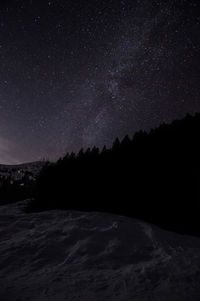 Scenic view of snowcapped mountains against sky at night