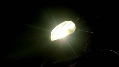 Low angle view of illuminated lamp against sky at night