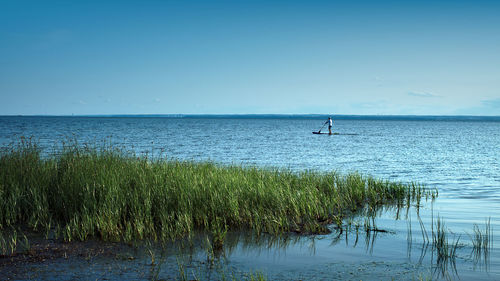 Scenic view of sea against blue sky