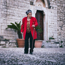 Full length of man standing against wall