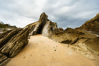 Panoramic view of rocks on beach against sky