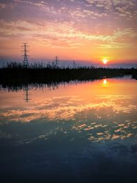 Scenic view of lake against romantic sky at sunset