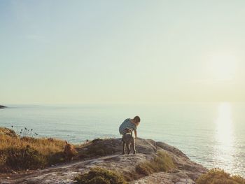 Man standing on sea shore against sky