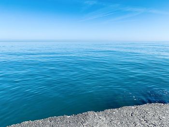 Scenic view of sea against blue sky