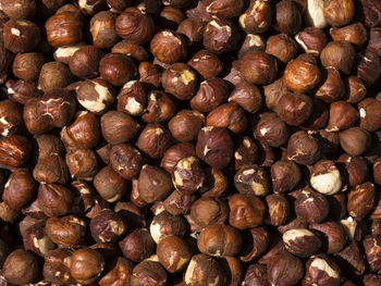 Full frame shot of hazelnuts for sale at market stall during sunny day
