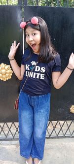 Portrait of a smiling girl standing outdoors