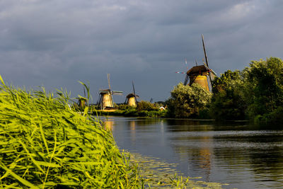 Beautiful wooden windmills at sunset in the dutch village of kinderdijk. windmills run on the wind.