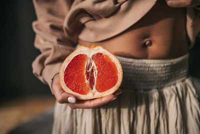 Close-up of woman holding fruit