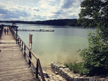 Pier over lake against sky