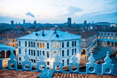 View of city buildings against cloudy sky