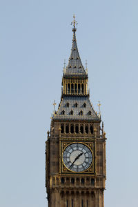 Low angle view of clock tower against sky