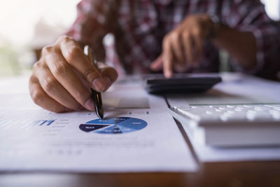 Midsection of businessman working in office