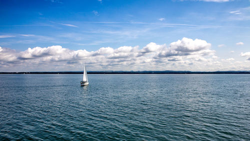 Sailboat sailing in sea against sky