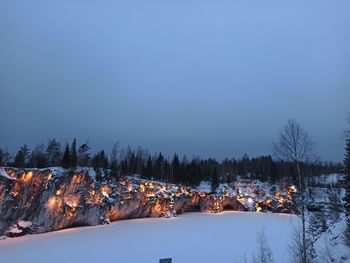 Snow covered trees against sky during winter