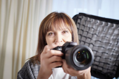 Young woman photographing through camera