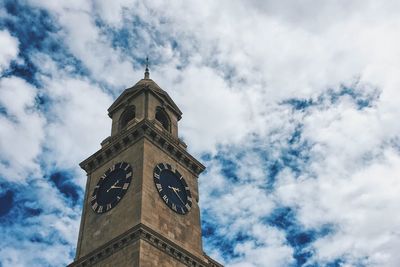 Low angle view of clock tower against sky