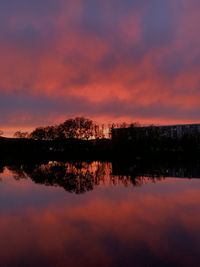 Scenic view of lake against romantic sky at sunset